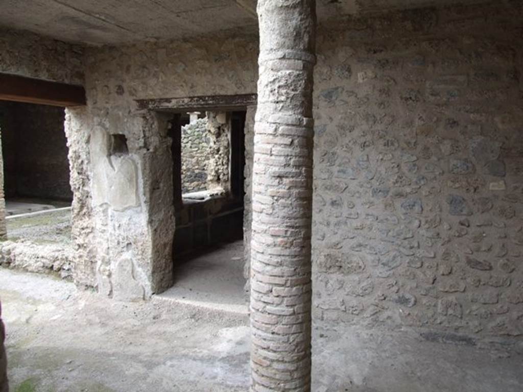 III.4.3  Pompeii.  March 2009.  Room 12. Courtyard, Looking north to portico area, and door to room 13 with window overlooking garden.  On the west side of the doorway, a square hole in the doorpost can be seen.  Originally this was covered with glass, and would have contained a lamp for lighting the passageway at night.  See Jashemski, W. F., 1993. The Gardens of Pompeii, Volume II: Appendices. New York: Caratzas. (p.102).