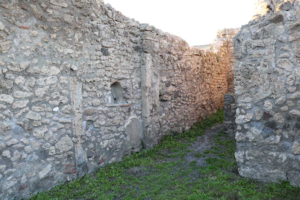 V.2.9 Pompeii. December 2018. Looking towards west wall of shop, with lararium niche. Photo courtesy of Aude Durand.