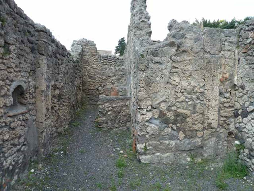 V.2.9 Pompeii. May 2010. West side of shop, looking north to rear room.