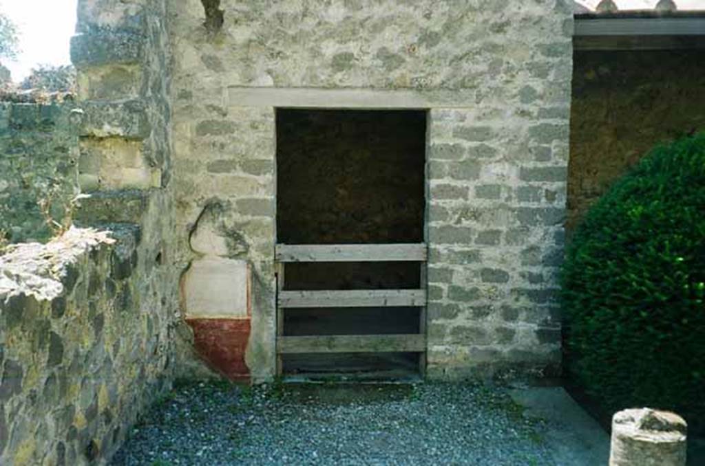 VI.2.4 Pompeii. June 2010. Doorway to cubiculum in south-east corner of garden apartment. Photo courtesy of Rick Bauer.
It should be noted that, apart from the west side, the house was entirely destroyed by the bombing during the night of 14/15th September 1943. 
According to Laidlaw, the roof, the south apartment, and the portico behind the main house block are almost completely modern reconstructions made in 1970-71.
See Garcia y Garcia, L., 2006. Danni di guerra a Pompei. Rome: L’Erma di Bretschneider. (p. 66-74).
According to Scafati –
“In the cubiculum to the left (the one in the south-east corner of garden area) were found, eight small columns of bronze and remains of gilt wood which formed part of a bed.”
See Scafati, Guide to Pompeii Illustrated, 1900. p.105-106.
