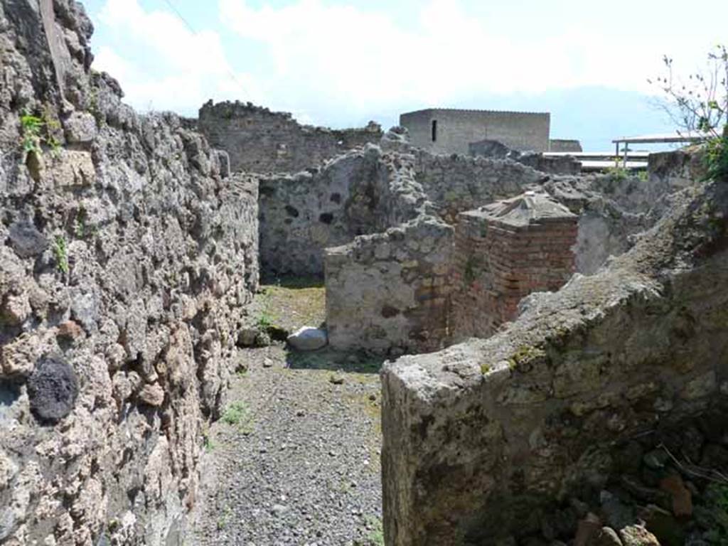 VI.3.10 Pompeii. May 2010. Looking south across rear, from room on north side, across yard towards the kitchen and latrine.
