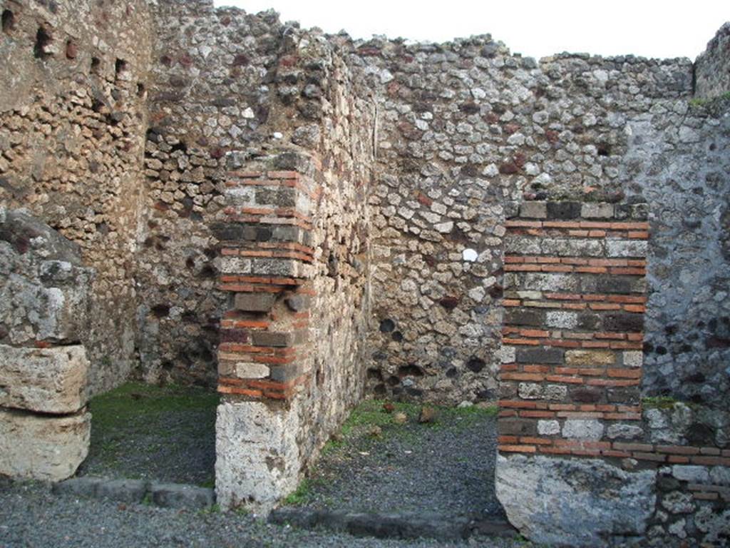 VI.3.17 Pompeii. December 2004.Doorways to two rooms on east side of shop-room.