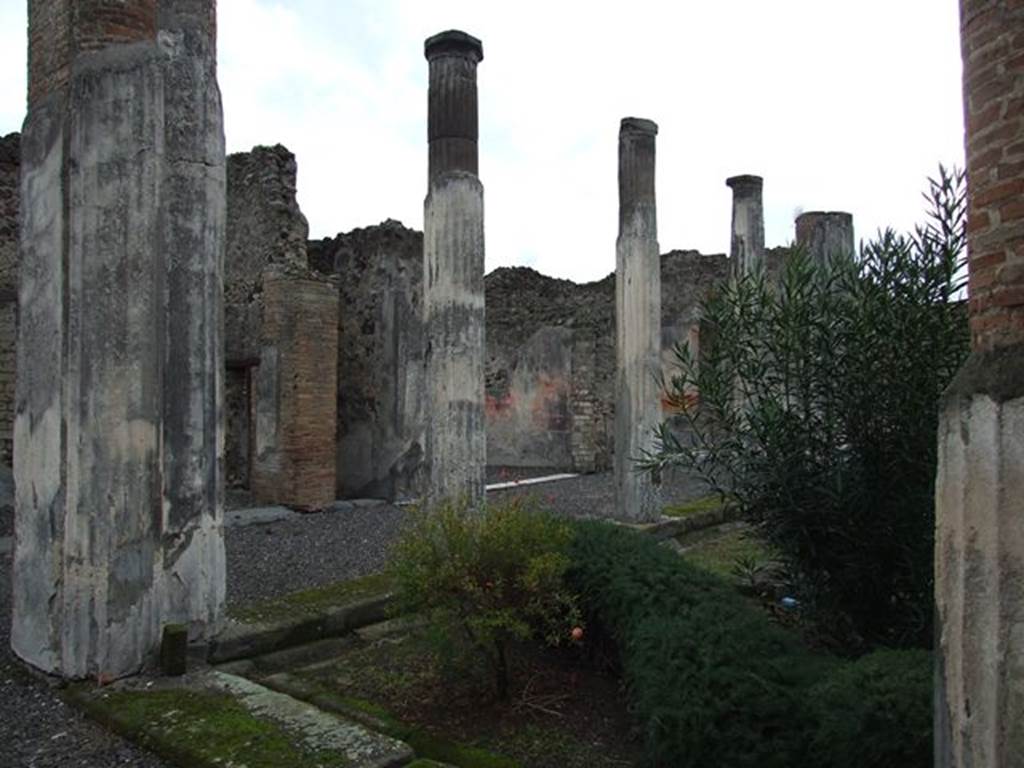 VI.7.20 Pompeii. December 2006. Looking south-east across peristyle from north portico, towards south wall of small exedra with doorway, corridor to atrium, tablinum and large oecus.
