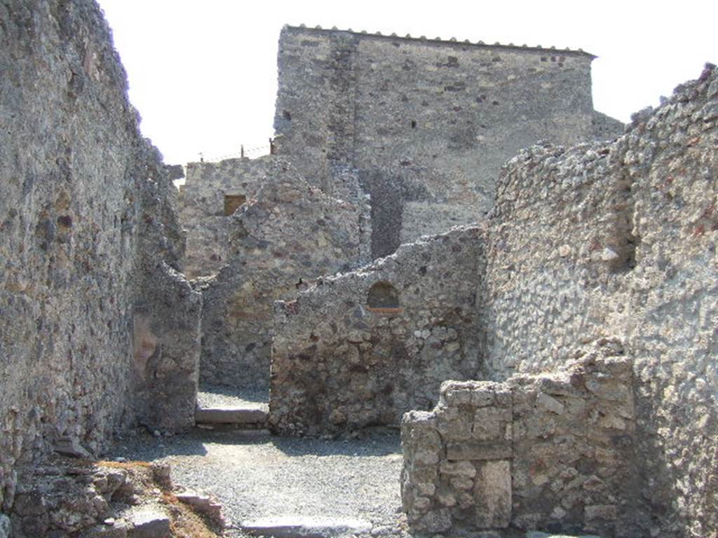 VI.8.15 Pompeii. December 2007. Looking across middle rear room, with lararium niche and doorway in west wall. The doorway has two steps to another small rear room.
