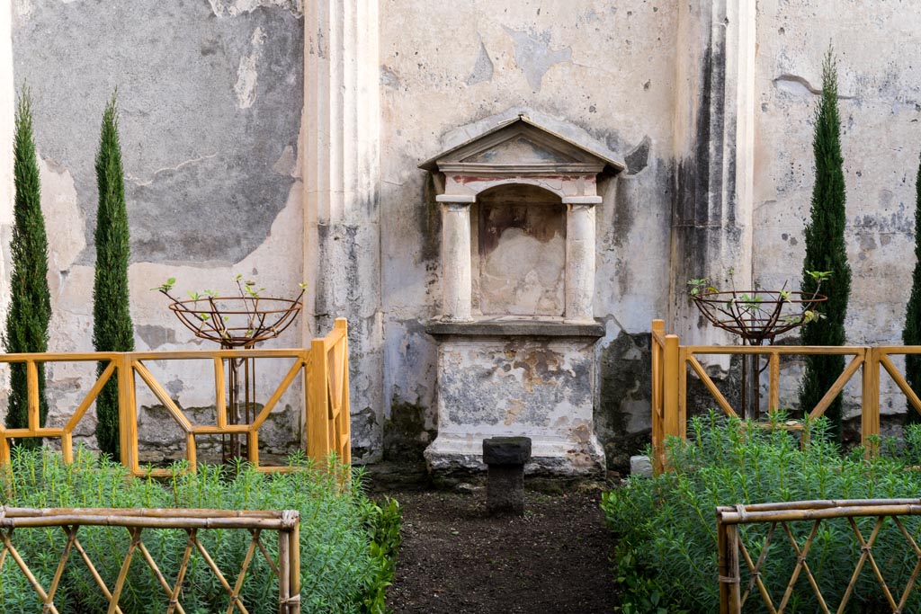 VI.9.6 Pompeii. January 2023. Room 17, lararium against east wall of pseudo-peristyle. Photo courtesy of Johannes Eber.
The fences and cypress grove planting reflect the original painting on the east wall as shown by Gell, above.
