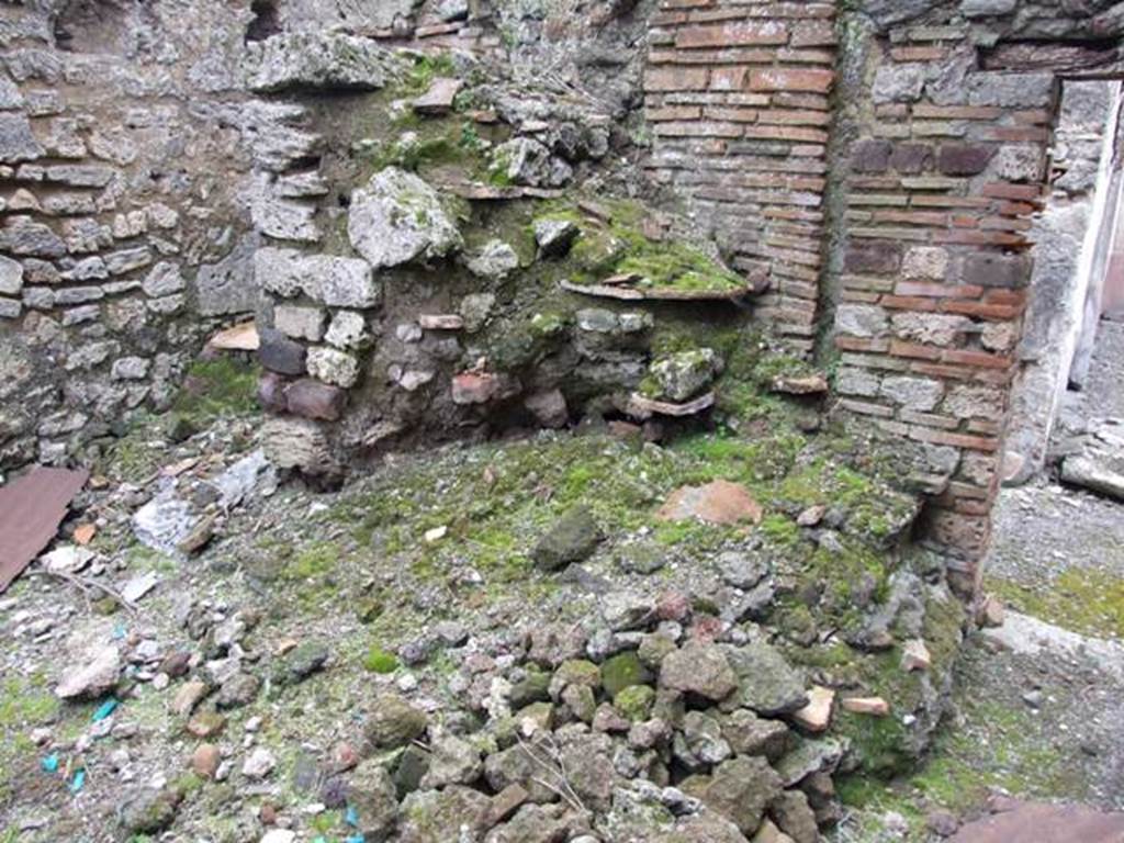 VI.10.11 Pompeii. March 2009. Room 13, partially collapsed masonry staircase to upper floor in kitchen area. The slabs of terracotta that formed the stair treads can be seen.
