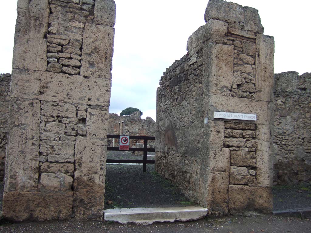 VI.13.6 Pompeii. December 2005. Entrance doorway.
According to Pagano and Prisciandaro, found in April 1841 were recommendations on the exterior walls of VI.13.6-9. They read –

Fuscum aed(ilem)
Iphigenia facit    [CIL IV 457]

Vicini
cum Capitone
rog(ant)    [CIL IV 458]

R]ustium aed(ilem)
rogamus dignus est    [CIL IV 459]

Paquium et Caprasium
probissimos d(uum)v(iros) i(ure) d(icundo) o(ro) v(os) f(aciatis)    [CIL IV 460]

M(arcum) Samellium Modestum aed(ilem)
d(ignum) r(ei) p(ublicae) o(ro) v(os) f(aciatis)    [CIL IV 465]

See Pagano, M. and Prisciandaro, R., 2006. Studio sulle provenienze degli oggetti rinvenuti negli scavi borbonici del regno di Napoli. Naples: Nicola Longobardi, (p.157),  PAH II, 395; III, 169.
