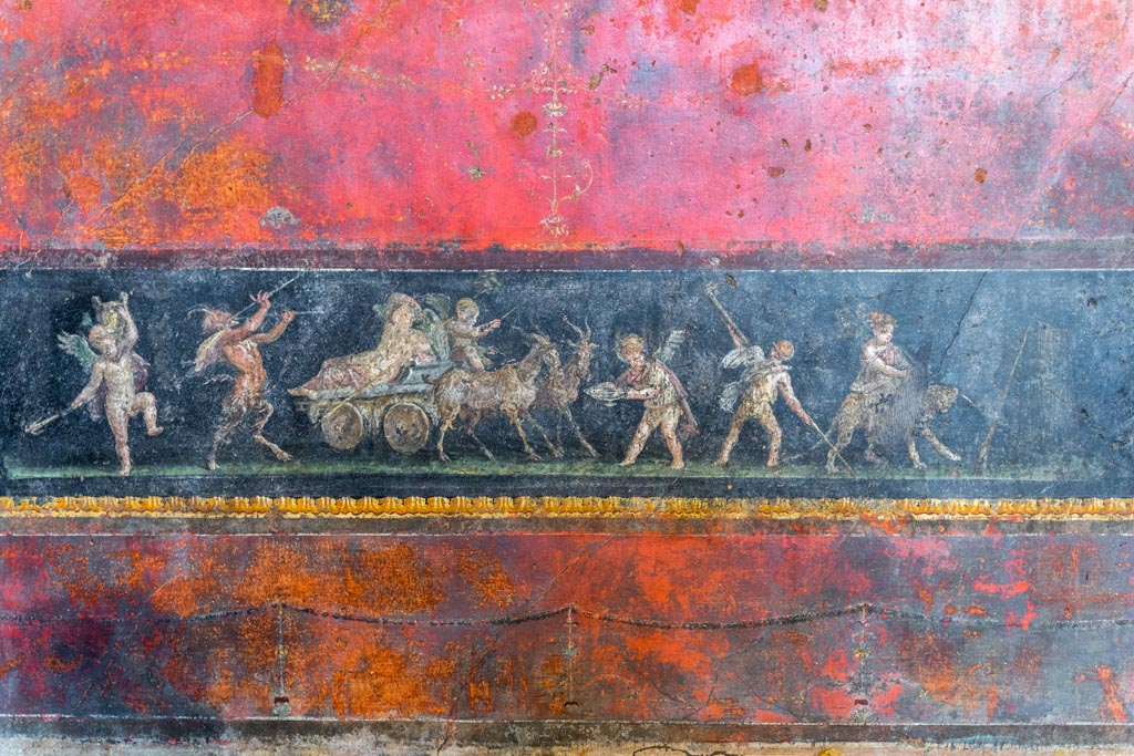 VI.15.1 Pompeii. March 2023. 
Lower north wall in north-west corner with painting of cupids celebrating a festival in honour of Bacchus. Photo courtesy of Johannes Eber
