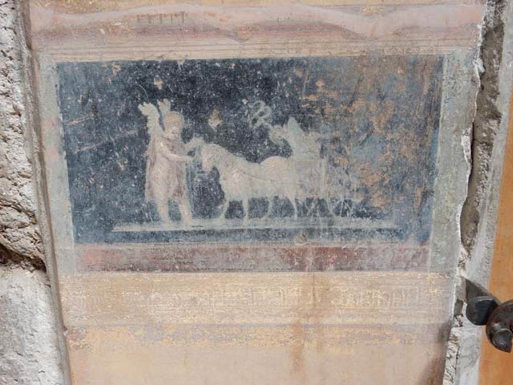 VI.15.1 Pompeii. October 2023. Painted panel on atrium wall between doorways. Photo courtesy of Klaus Heese.