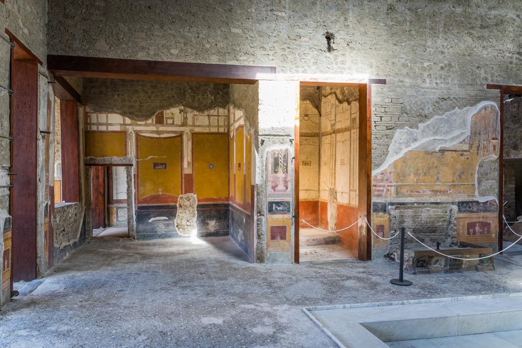 VI.15.1 Pompeii. October 2023. Painted panel on atrium wall between doorways. Photo courtesy of Klaus Heese.