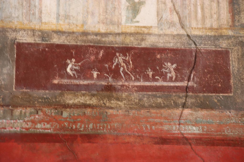 VI.15.1 Pompeii. October 2023. 
Upper north wall of exedra, detail of painted figures on panel towards east end. Photo courtesy of Klaus Heese. 

