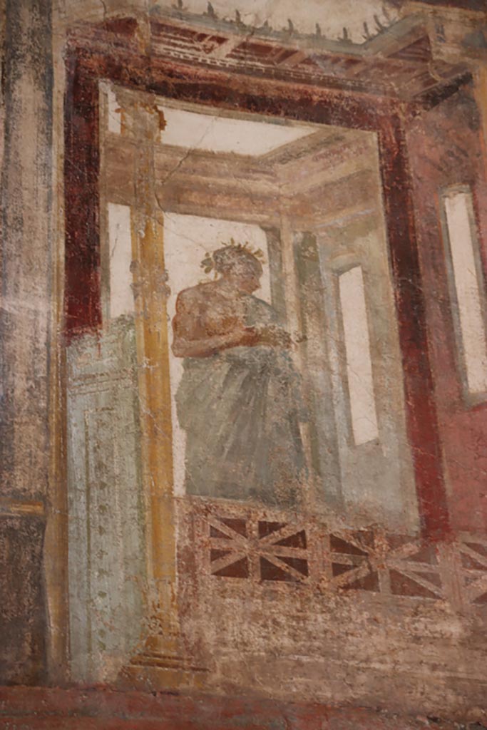 VI.15.1 Pompeii. October 2023. 
Upper north wall of exedra at east end, detail of painted figure. Photo courtesy of Klaus Heese. 
