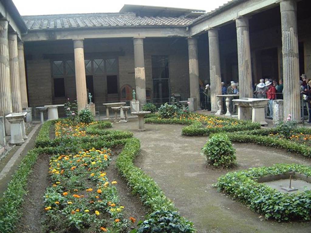 VI.15.1 Pompeii. Peristyle. View of garden looking north in May 2001. Photograph courtesy of Current Archaeology.
According to Jashemski, 
“water from 12 fountain statuettes (2 bronze and 10 marble) on bases placed between the columns of the portico, jetted into 8 marble basins which stood in the water channel at the edge of the garden. 9 of the fountain statuettes were preserved and used to be on display in the garden.  In 1978, the 4 fountain statuettes from the north end of the garden were stolen, eventually being recovered, but in pieces. The remaining statuettes were removed for safe keeping".
See Jashemski, W. F., 1993. The Gardens of Pompeii, Volume II: Appendices. New York: Caratzas. (p.153-54)

