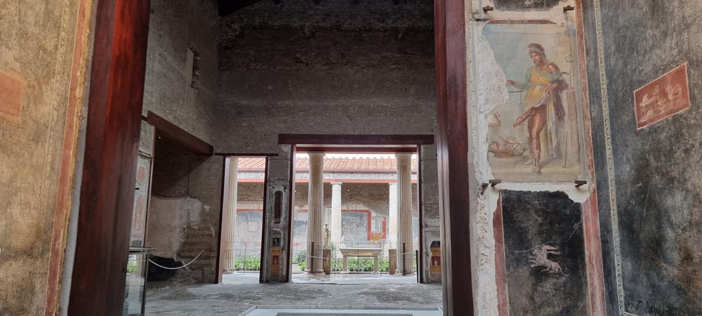 VI.15.1 Pompeii. January 2023. 
Looking west from vestibule towards south-west corner of atrium and through to peristyle. Photo courtesy of Miriam Colomer.
