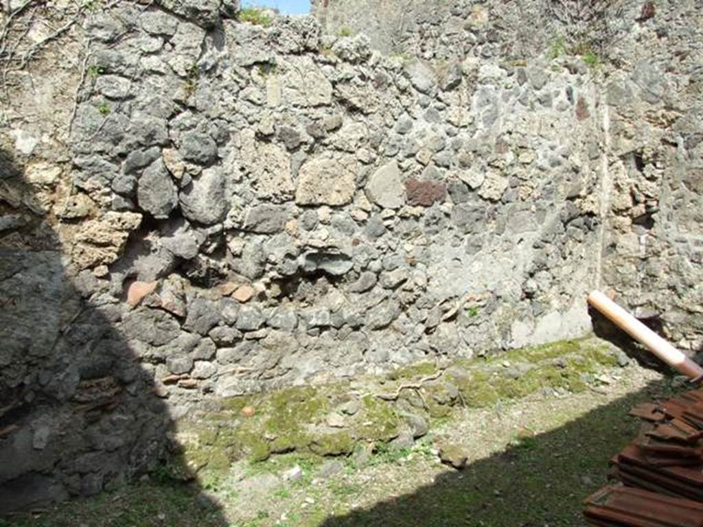 VI.15.6 Pompeii. March 2009.  Room 11.  Storeroom. North wall and north west corner, with remains of bench?.