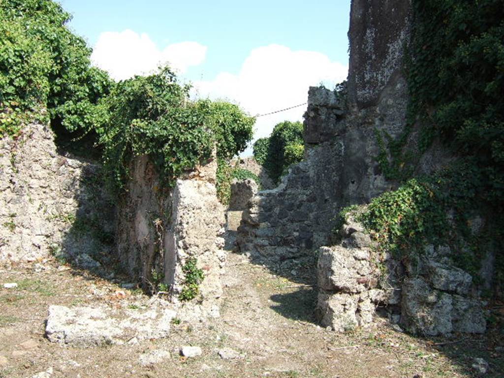 VI.15.20 Pompeii. September 2005. South-east side of atrium, with tablinum, left, and doorway to cubiculum, right. According to NdS, this room also had walls of white coarse plaster.
