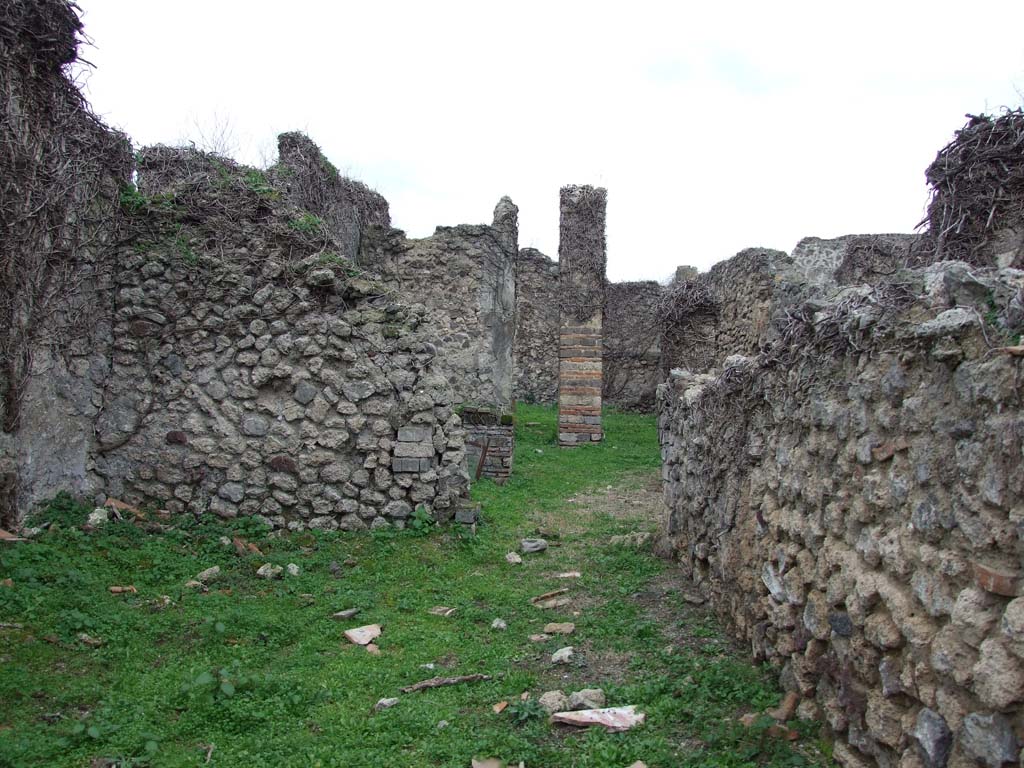 VI.16.10 Pompeii. December 2007. Doorway to atrium or corridor in rear wall of shop.
According to NdS, by an open space in the west wall one entered into a corridor with white walls and red horizontal band at the height of the dado.

