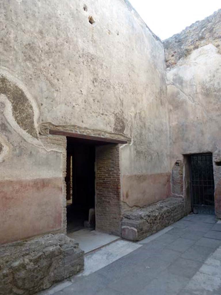 VII.1.14 Pompeii. June 2012. Looking north-west across waiting room 2a of Stabian baths. The doorway in the centre leads into the mens changing room 2. The gated doorway, on the right, would lead towards VII.1.15. Photo courtesy of Michael Binns.