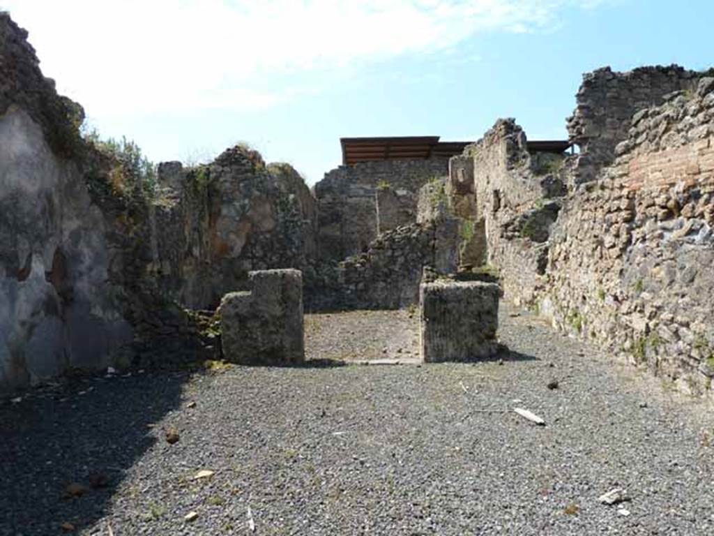 VII.1.27 Pompeii. May 2010. Looking west across the shop-room towards a rear room and corridor.