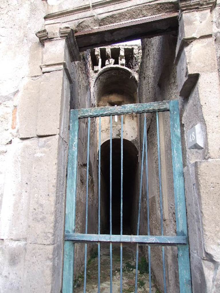 VII.1.48 Pompeii. December 2006. Looking east through small doorway of Stabian Baths along corridor K. 