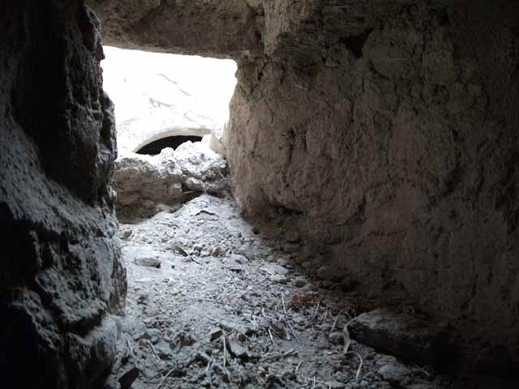 VII.16.a Pompeii. May 2010. Corridor 13, looking through first small window in west wall into room 9, at the rear of the nymphaeum.