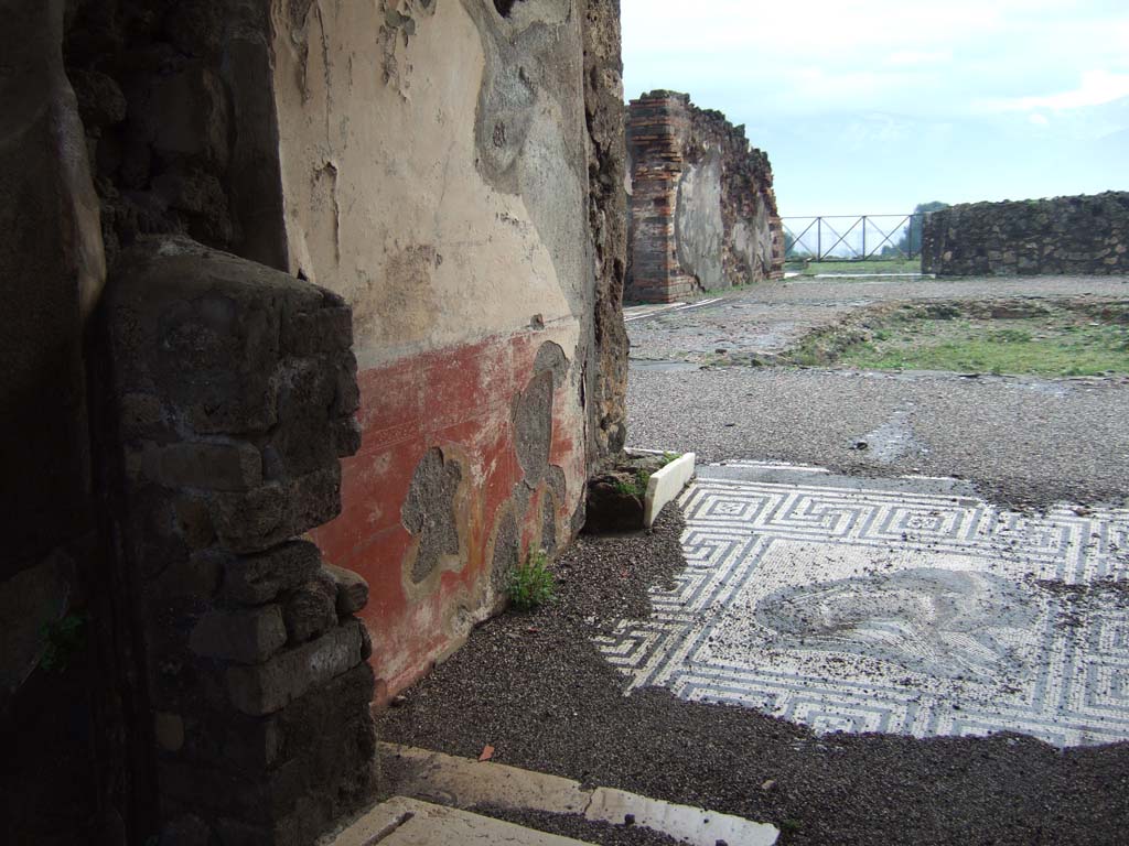 VIII.2.26 Pompeii. December 2005. Painted wall decoration on east wall of vestibule ‘b’, with painted female figure, just visible. 
According to NdS – 
“on the left wall (east) was another crowned female figure (0.48 high), with yellow robe and greenish cloak, between her hands was a long torch.”
See Notizie degli Scavi di Antichità, 1888, (p. 512)
