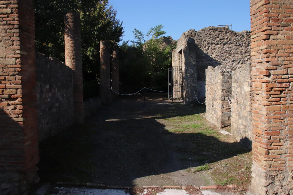 VIII.5.16 Pompeii. October 2022. 
Looking west from room 5, along north portico towards entrance doorway. Photo courtesy of Klaus Heese. 
