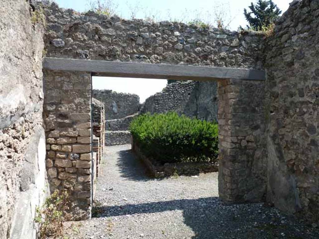 VIII.5.24 Pompeii. May 2010. Room 11, east wall with large doorway onto peristyle.