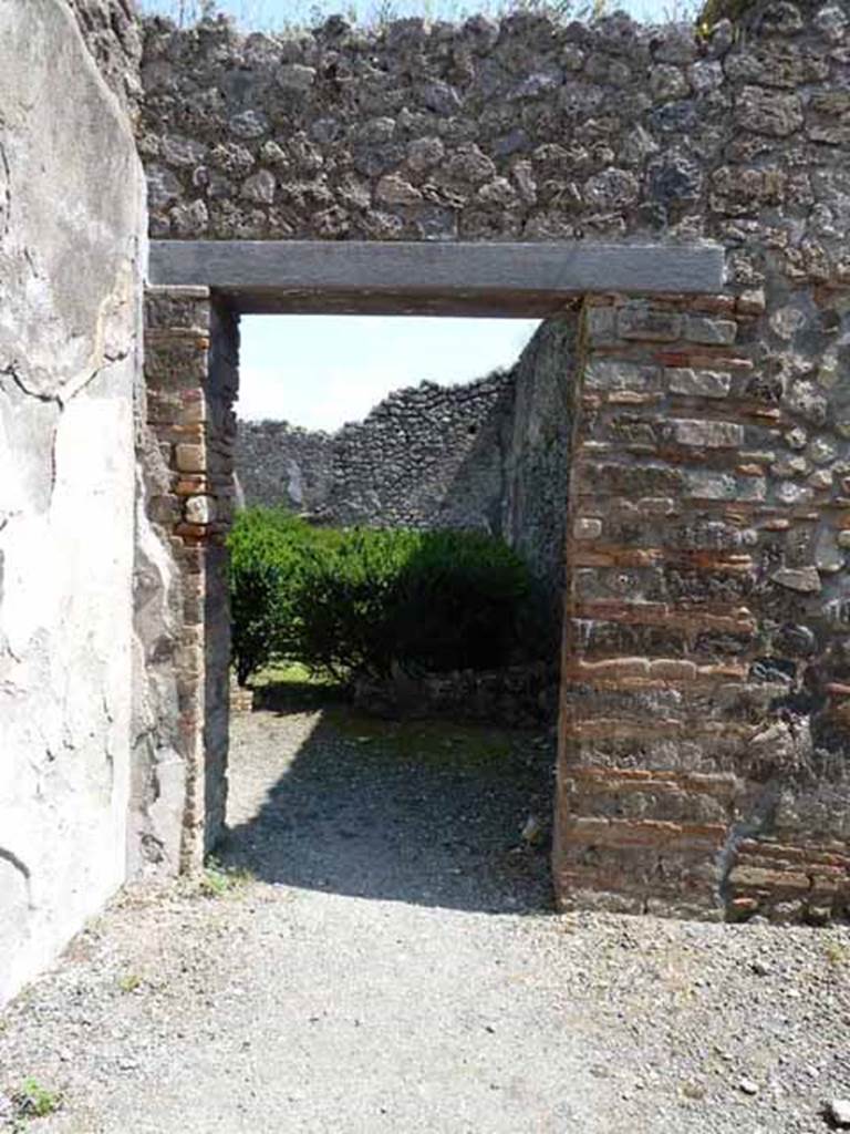 VIII.5.24 Pompeii. May 2010. Room 13, east wall with doorway to peristyle.