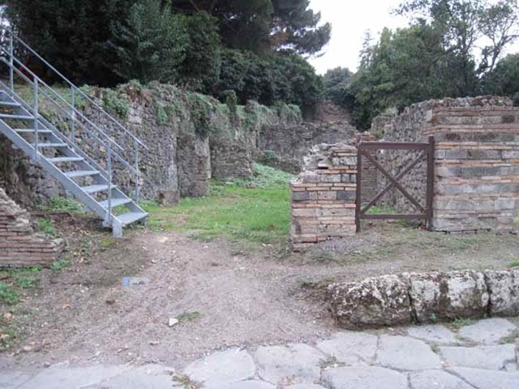 VIII.7.2 Pompeii. September 2010. Entrance on Via Stabiana. Looking west (across street). VIII.7.2 entrance is the square gate.  Photo courtesy of Drew Baker.
