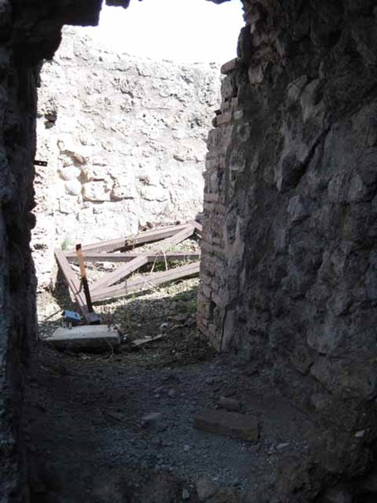 VIII.7.24 Pompeii. September 2010. Looking immediately east from entrance of storage room, towards small room in south-east corner of atrium. Photo courtesy of Drew Baker.
