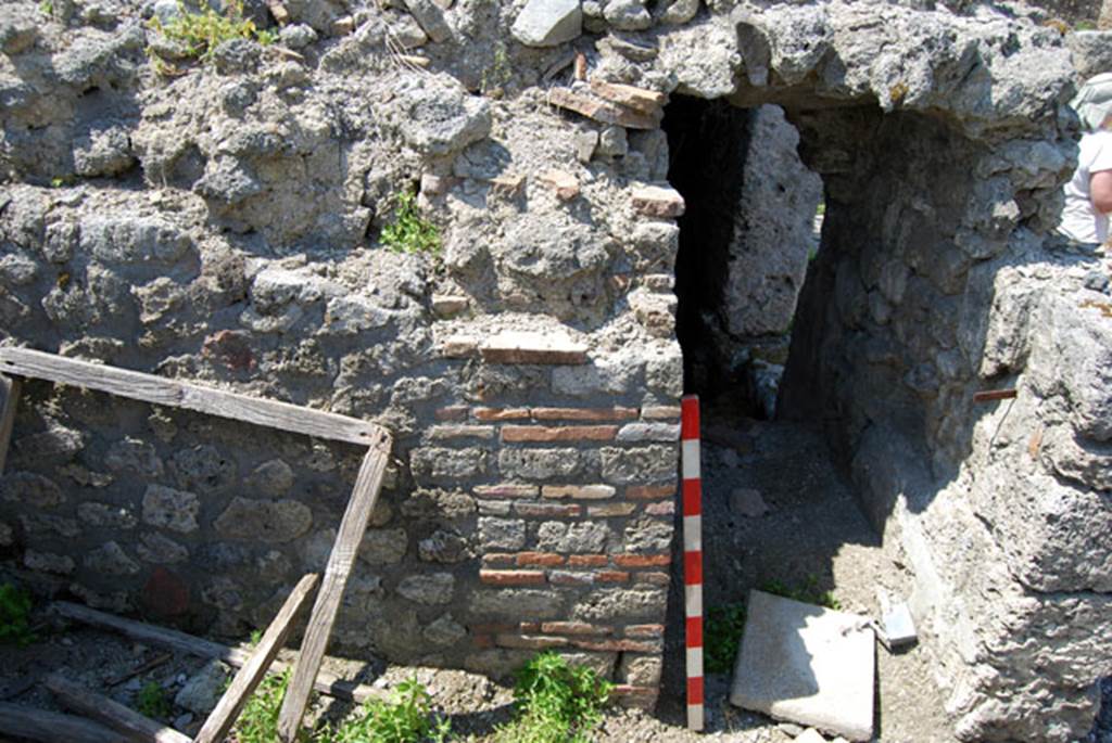 VIII.7.24 Pompeii. June 2009. West wall and entrance leading along corridor into storage room.  Photo courtesy of Sera Baker.
