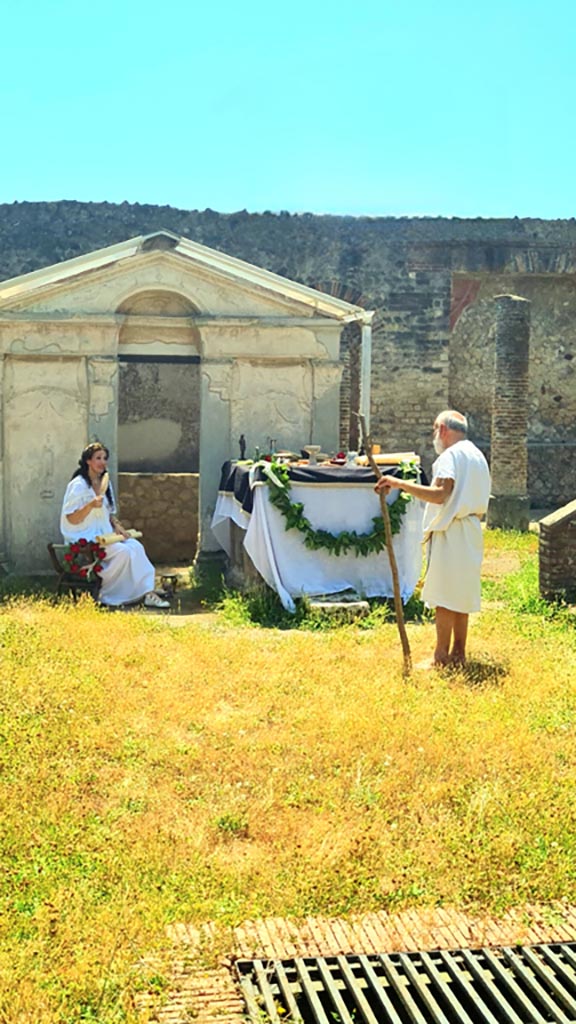 VIII.7.28 Pompeii. 8th June 2024. 
Looking south across temple court. Photo courtesy of Giuseppe Ciaramella.
Historical reconstruction entitled L’altra Pompei prende vita (The other Pompeii comes to life).

