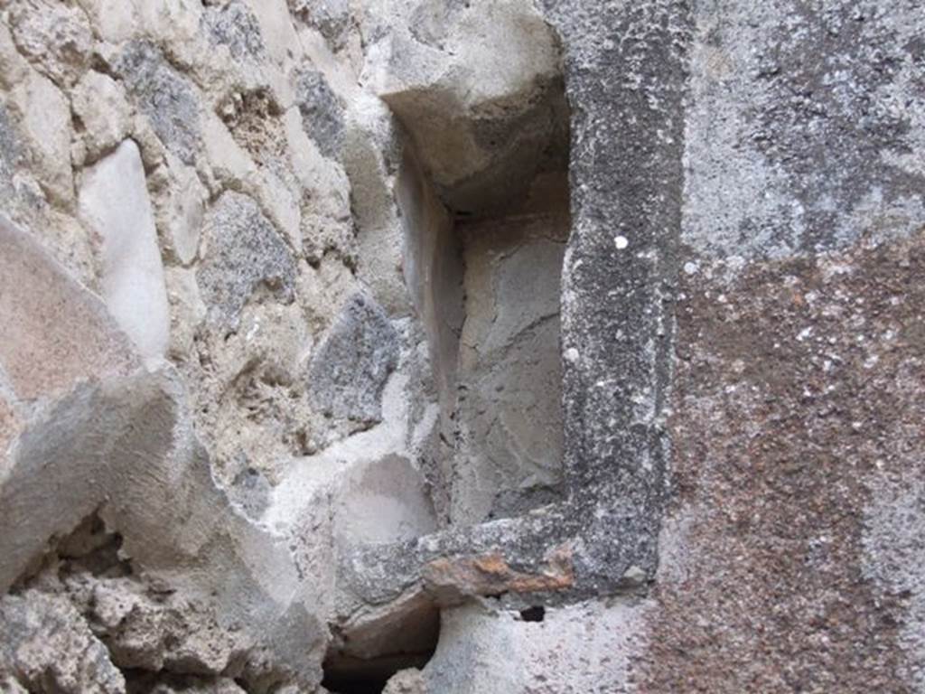 IX.1.12 December 2007. Recess on east wall above door to room on east side of peristyle.