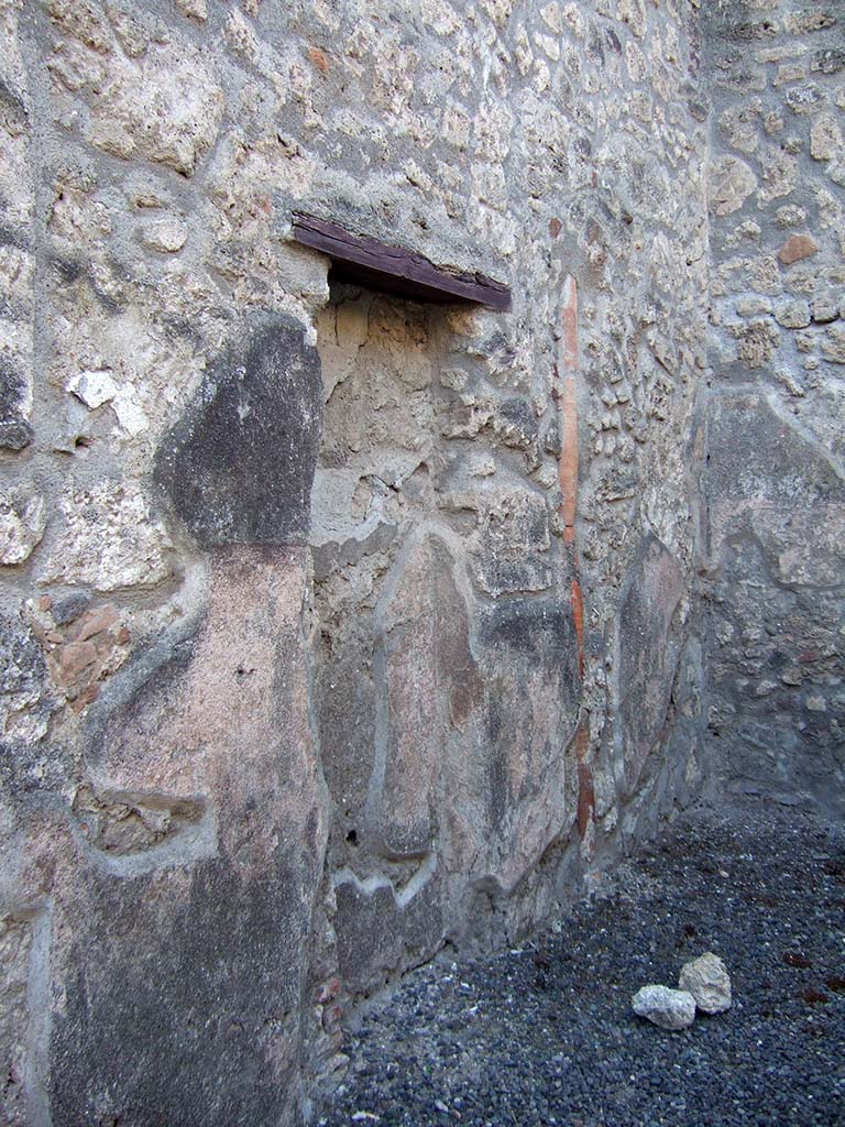 IX.1.23 Pompeii. September 2005. West wall of shop with recess, or blocked door from antiquity, and downpipe.
According to Fiorelli, this shop had belonged to the same house at IX.1.22, so the blocked doorway would have originally led into the entrance corridor of that house.
See Fiorelli, G. (1875). Descrizione di Pompei, (p.376)
See Pappalardo, U., 2001. La Descrizione di Pompei per Giuseppe Fiorelli (1875). Napoli: Massa Editore. (p.140)
According to Hobson, there was a downpipe in the west wall, and that Eschebach had indicated a latrine.
See Hobson, B., 2009. Pompeii, Latrines and Down Pipes. BAR International series 2041. Oxford. Hadrian Books. (p.475).
According to Eschebach, there was a latrine under the steps to the upper floor.
See Eschebach, L., 1993. Gebudeverzeichnis und Stadtplan der antiken Stadt Pompeji. Kln: Bhlau. (p.403).
