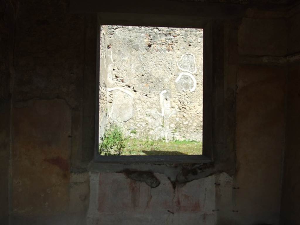 IX.2.5 Pompeii. March 2009. Triclinium, window in east wall, overlooking garden. In the middle of the yellow side panels were medallions, but it is no longer possible to determine their identity. Sogliano identified one of Paris with a cupid, and the other of Helen, but that was nearly vanished. He did not give their location in the room. A bust of Paris wearing a green hat, with cupid on his right shoulder (p.105, no.558), A bust of Helen, turning to the left, in response to no.558, faded and vanishing (p.108, no.567).
See Sogliano, A., 1879. Le pitture murali campane scoverte negli anni 1867-79. Napoli: Giannini. 
According to PPP, there would have been medallions in all of the side panels of the walls, mostly undistinguishable when found.
See Bragantini, de Vos, Badoni, 1986. Pitture e Pavimenti di Pompei, Parte 3. Rome: ICCD. (p.406).
According to Fiorelli, A bust of Paris was also found here, with crook on one shoulder and a cupid on the other caressing his chin; and also a veiled Helen. Another two busts similar to the previous were seen, of a crowned poet and of a writer, both enclosed in a medallion, as well as four landscapes of countryside or marine.
See Fiorelli, G, (1875). Descrizione di Pompeii (p.379).
See Pappalardo, U., 2001. La Descrizione di Pompei per Giuseppe Fiorelli (1875). Napoli: Massa Editore. (p.141).
