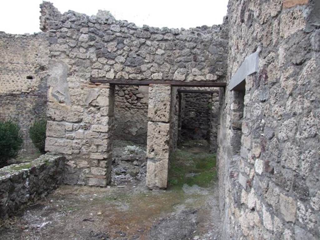 IX.2.10 Pompeii. December 2007. Rooms next to the north wall to the east of the peristyle.Small room or cupboard on left, and corridor to narrow room, kitchen and latrine on right.
