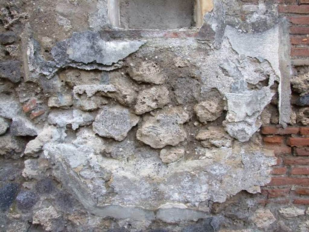 IX.2.24 Pompeii. March 2009. West wall under niche. Lower part of Lararium painting.  One very small part of a serpent is all that can still be seen. 
See Frhlich, T., 1991, Lararien und Fassadenbilder in den Vesuvstdten.  Mainz: von Zabern.  (L99: p.293, T. 42, 3). 
According to Boyce, in the lower zone a large serpent advanced from the right towards an altar furnished with offerings. Across the top of the whole painting was stretched a garland.
See Boyce G. K., 1937. Corpus of the Lararia of Pompeii. Rome: MAAR 14. (p. 82, no. 403 and Pl. 24, 2.) 
