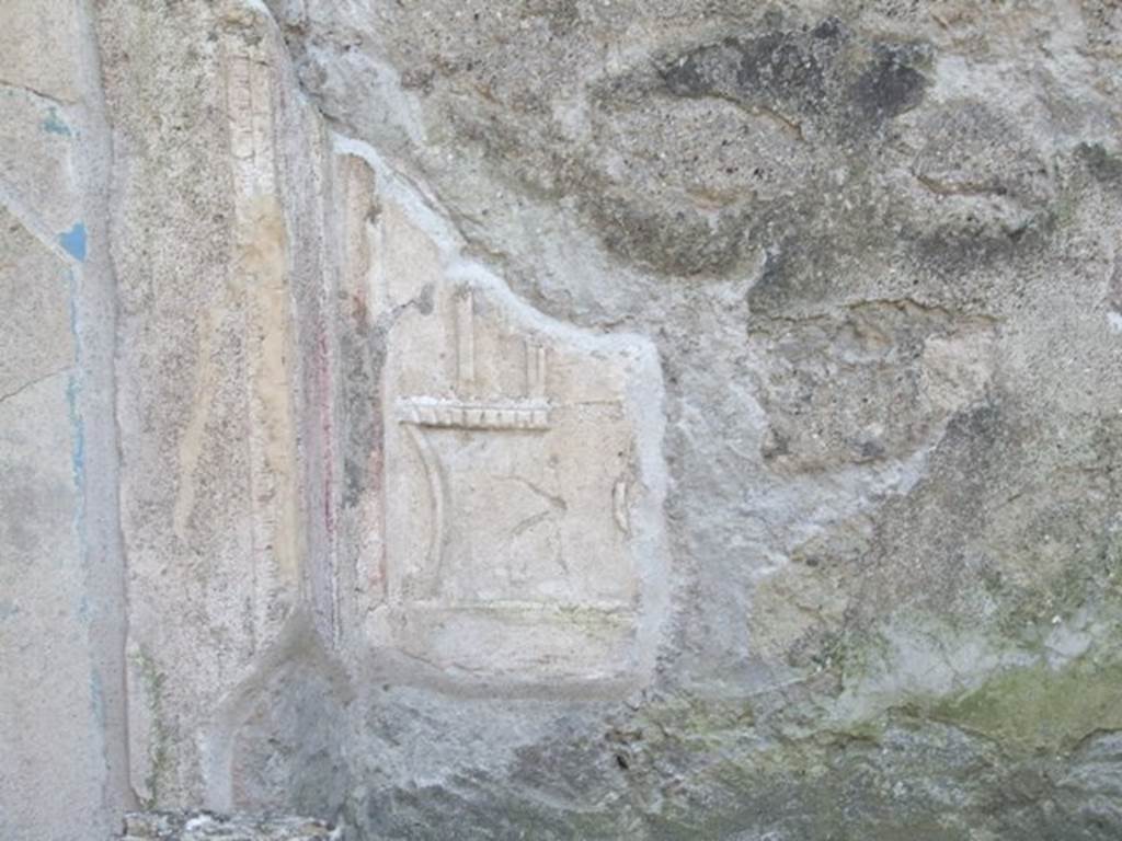 IX.3.5 Pompeii.  March 2009. Altar.  Remains of plaster decoration on west wall behind altar.