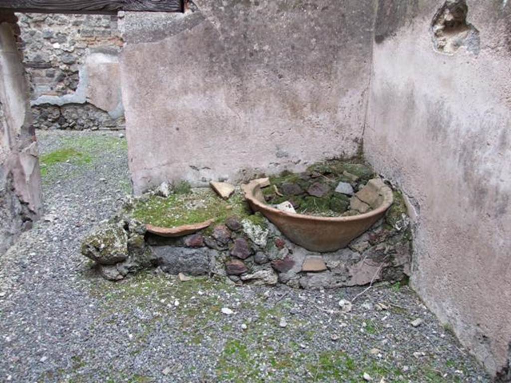 IX.3.20 Pompeii. December 2007. Room 4, east wall and doorway with remains of two terracotta basins. Found in this room were two lead-lined basins to conserve the water: at the rear was the baker’s room.
