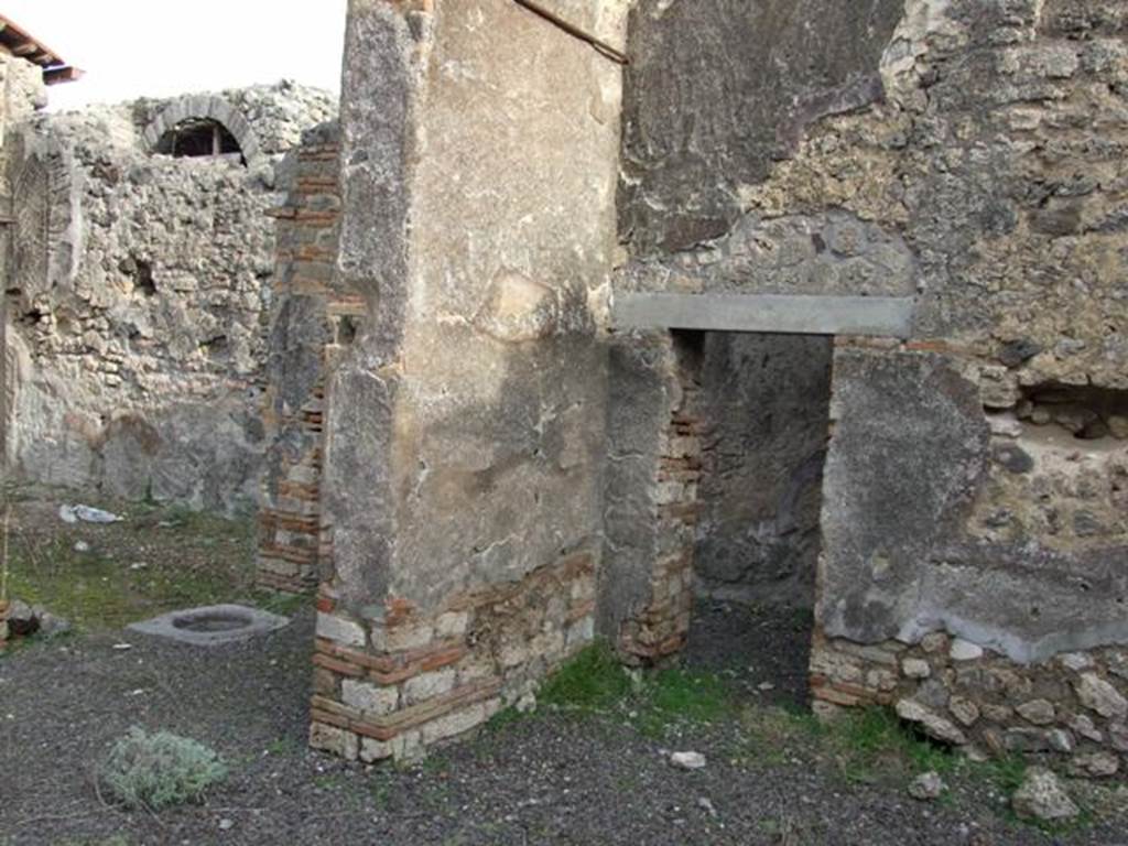 IX.5.2 Pompeii. December 2007. Room v, large exedra. 
Looking north-east to peristyle p (on left) and small door in east wall of corner of room v into corridor leading to rooms x and y.

