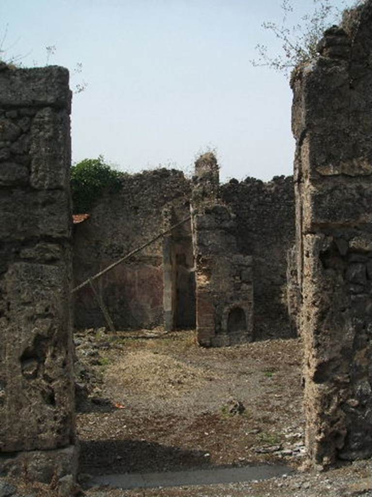 IX.6.8 Pompeii. May 2005. Entrance doorway, looking west across site of vestibule 1 and atrium 2. 
According to Della Corte, this was a small house of irregular plan with eight rooms grouped around an atrium.
He thought an obscure Amandus lived and worked here.
He said inscriptions like Quisquis amat per(eat)  [CIL IV 5186] and Messius hic nihil futuit     [CIL IV 5187] found written on the atrium walls, tended to prove this was a Lupanare, held by Amandus.
See Della Corte, M., 1965.  Case ed Abitanti di Pompei. Napoli: Fausto Fiorentino. (p.163)
