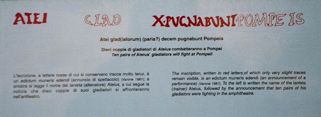 IX.8.2 Pompeii. October 2009. Explanation of painted latin inscription. Atei glad(iatorum) (paria?) decem pugnabunt Pompeis. Ten pairs of Ateius gladiators will fight at Pompeii. Photo courtesy of Rick Bauer.