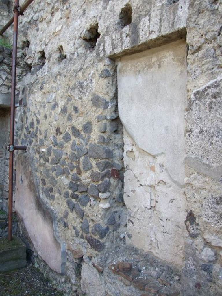 IX.9.c Pompeii. March 2009.  South wall of south-east corner of portico area, showing recess and above, the holes for the beam supports for the mezzanine floor.  

