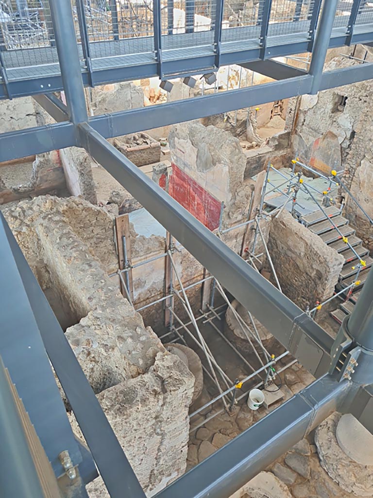 IX.12.6/4 Pompeii. June 2024. 
Looking west from above room “f” in bakery. The stairs descend into room “g”. Photo courtesy of Giuseppe Ciaramella.


