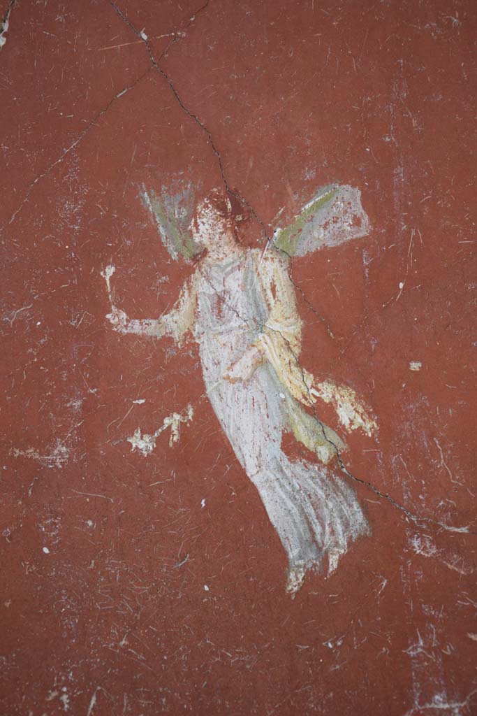 IX.12.6 Pompeii. February 2017. 
Room “m”, detail of painting of flying figure from north side of central painting on west wall.
Photo courtesy of Johannes Eber.

