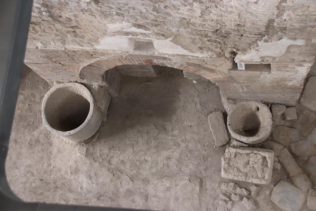 IX.12.6 Pompeii. October 2024. Room “e”, looking down with detail of oven “d” in bakery. Photo courtesy of Klaus Heese.