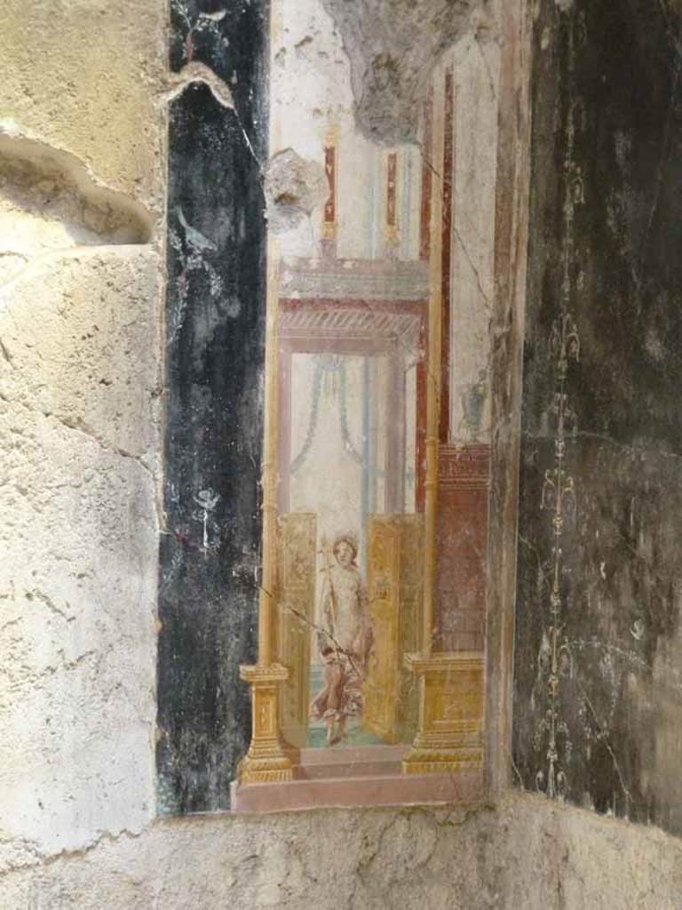 IX.12.9 Pompeii. May 2010. Room “u”, east wall, south panel. Architectural painting with figure in doorway.