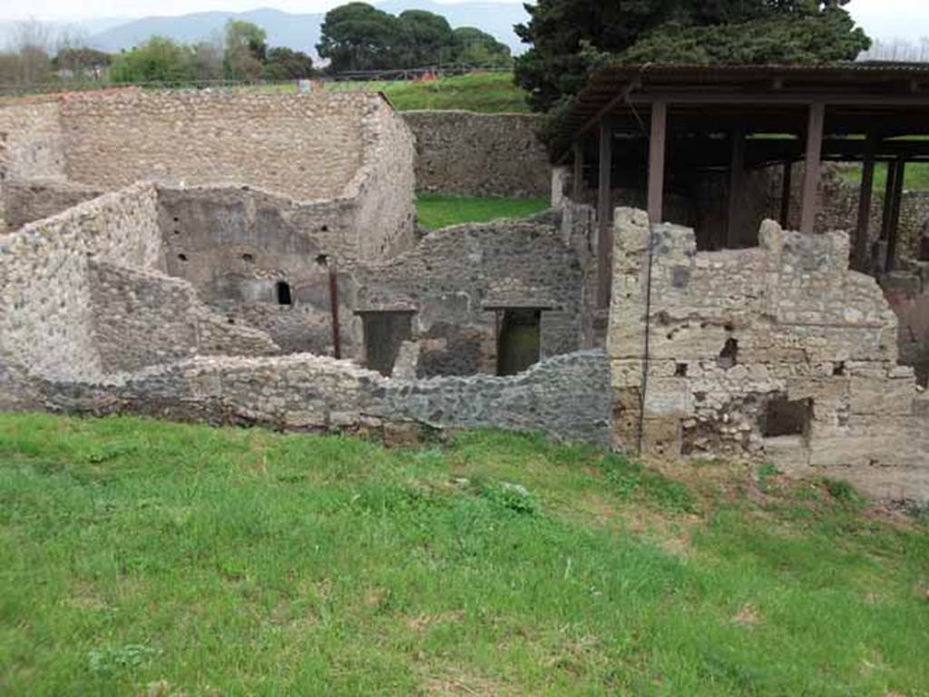 IX.14.b Pompeii, May 2010. Looking east at outside wall, with blocked entrance doorway. This led to the room on the left side of the picture..