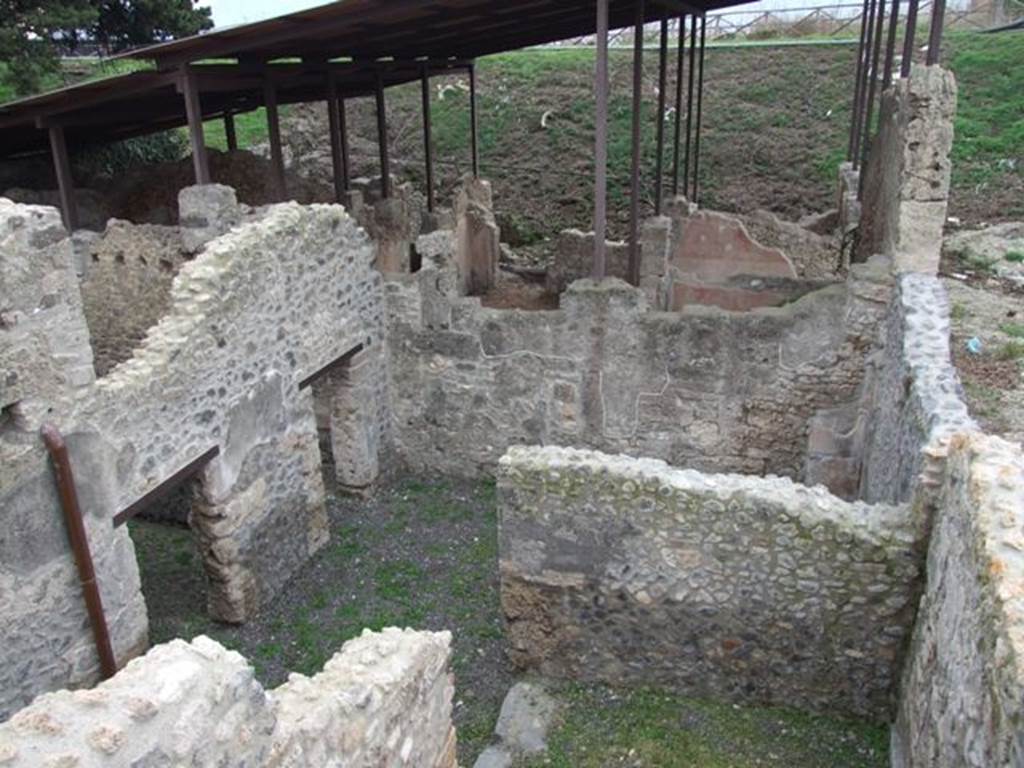 IX.14.b Pompeii. December 2007. Looking south from rear upper level into rooms in south west corner of IX.14.4. and to the entrance at IX.14.c. This blocked entrance is in the wall on the right of the picture.

